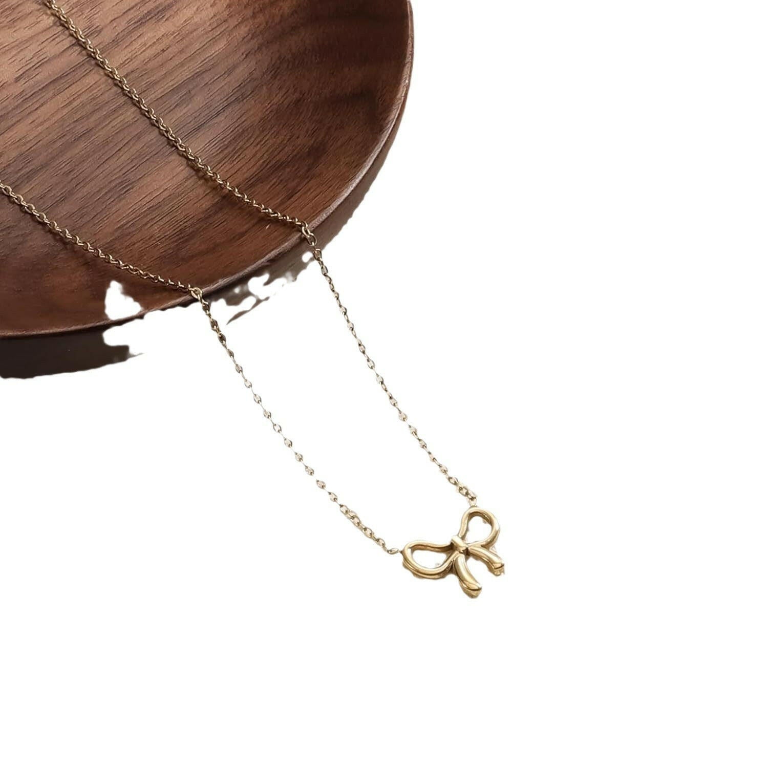 Kaze Minimalist Pearl Bow Necklace | Titanium Steel Pendant Necklace in Gold &amp; Silver